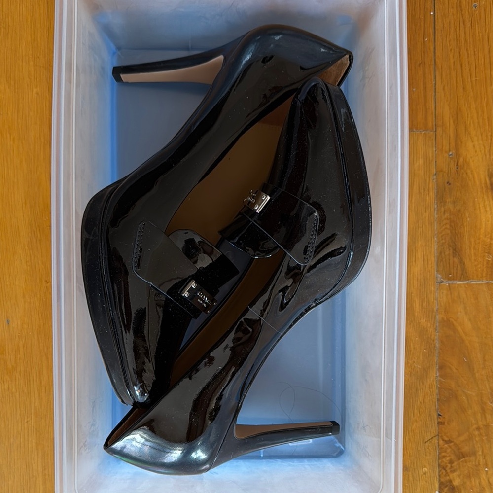Coach black patent leather heels with silver buckle.  4” heel.  Almost new.